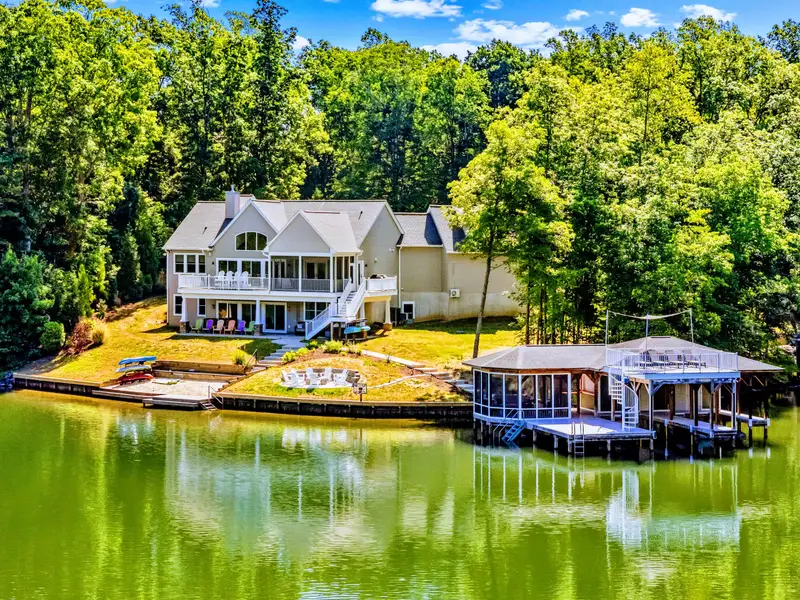 Aerial View - Lakefront from end to end, the home set back in the trees with its own dock and boathouse on the water.