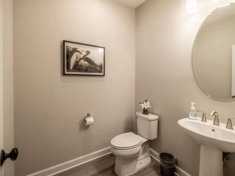 Powder Room - A convenient main-level half bath with a pedestal sink and clean finishes.
