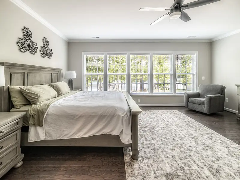 Primary Suite - Wake up to soft light and lake-facing windows in this spacious upper-level retreat.