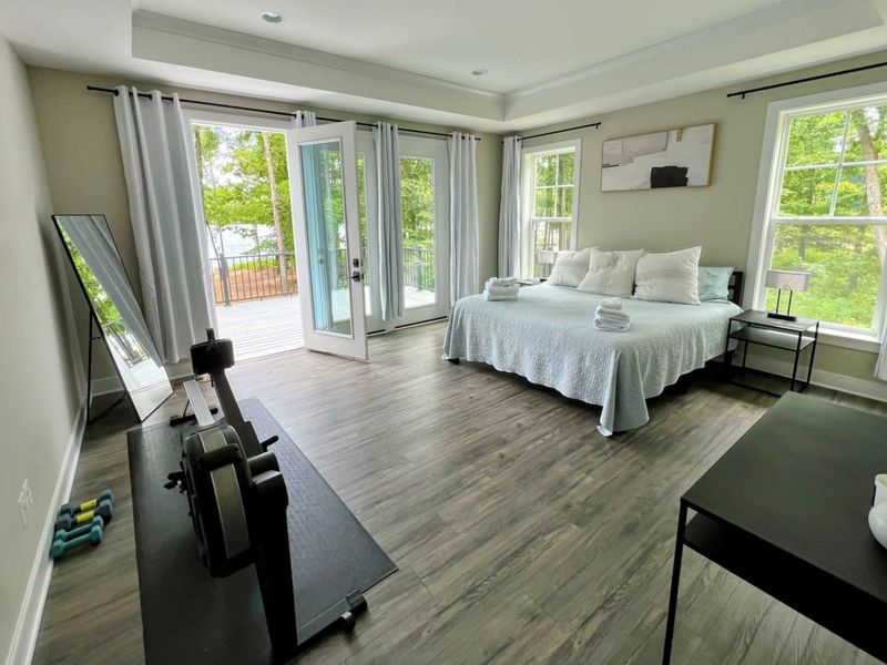 Large Primary Suite with easy access to the large deck and gorgeous water views.