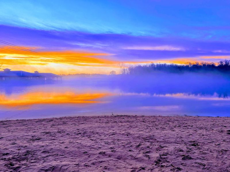 Sunrise from our 120 Foot Private Beach! You will love the 160+ feet of lakefront shoreline with a gently sloped naturally sandy lake bottom, and warm freshwater.