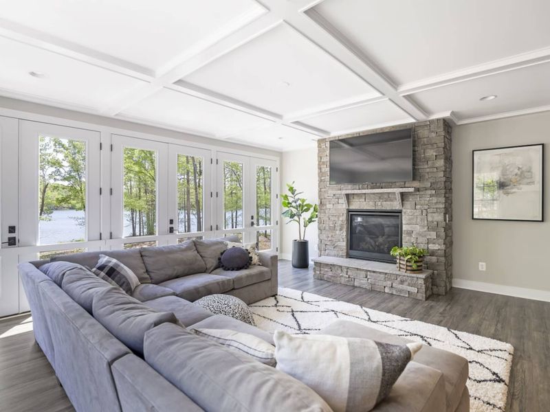 Open living room with amazing water views, comfy couch, Smart TV, and gas fireplace.
