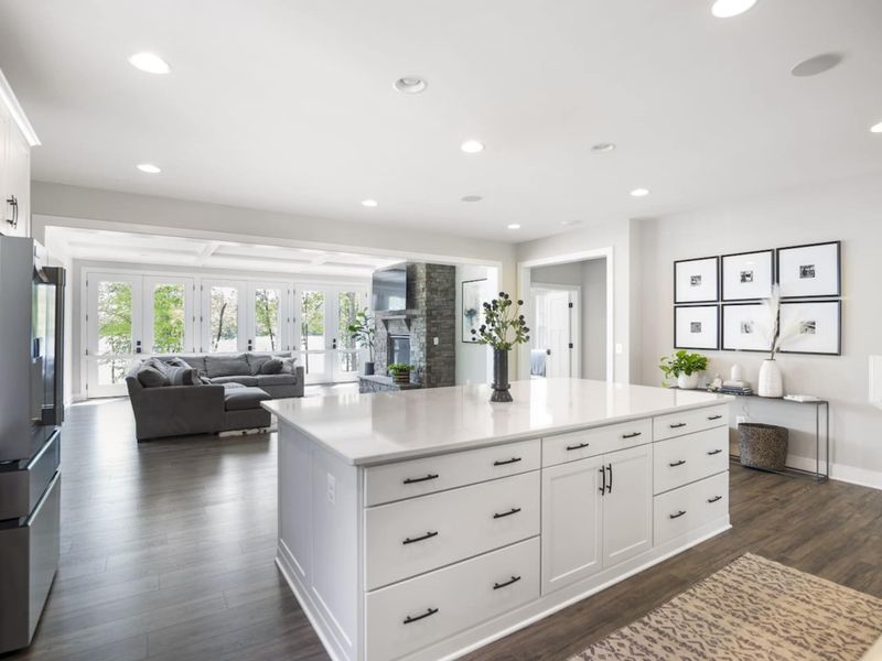 Large fully stocked kitchen with huge island, new stainless steel appliances, and large walk-in pantry.