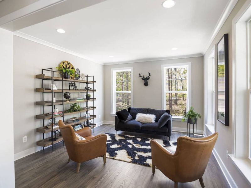 Cozy Den with seating, games, books, and a record player.