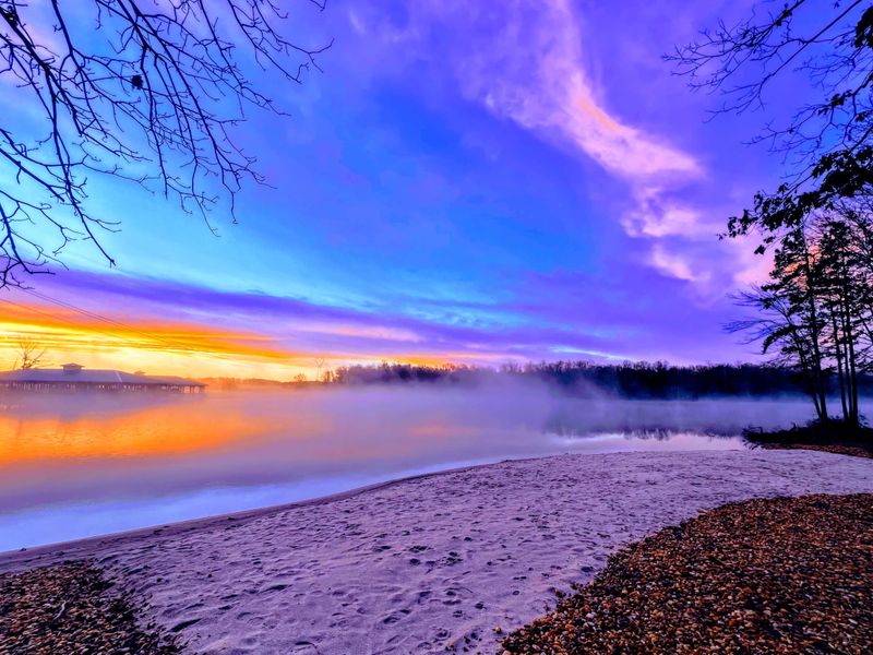 Sunrise from our 120 Foot Private Beach! You will love the 160+ feet of lakefront shoreline with a gently sloped naturally sandy lake bottom, and warm freshwater.