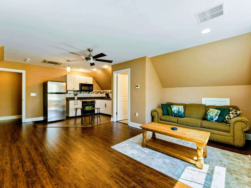 Large upper level suite with queen bed, fully stocked kitchen, desk, and bathroom.