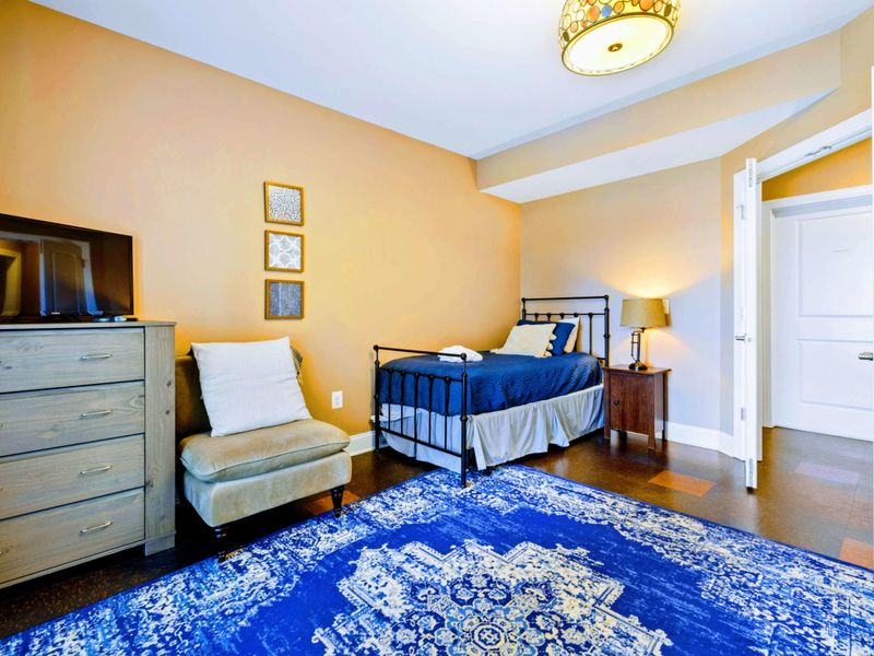 Lower level bedroom with two twin beds and a walkout patio.
