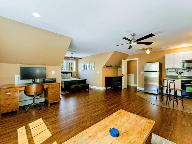 Large upper level suite with queen bed, fully stocked kitchen, desk, and bathroom.