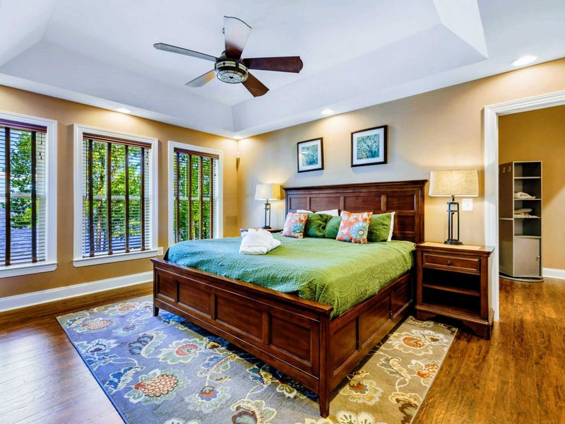 Suite with king bed, fireplace, TV, and jetted tub.