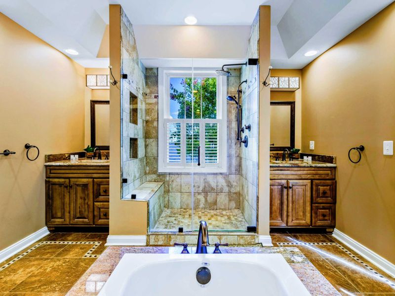 Suite bathroom with dual vanities, shower and jetted tub.