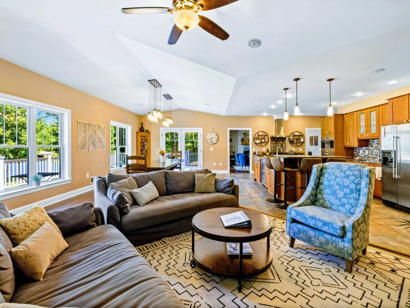 Open living room with amazing water views, comfy couches, Smart TV, and fireplace.