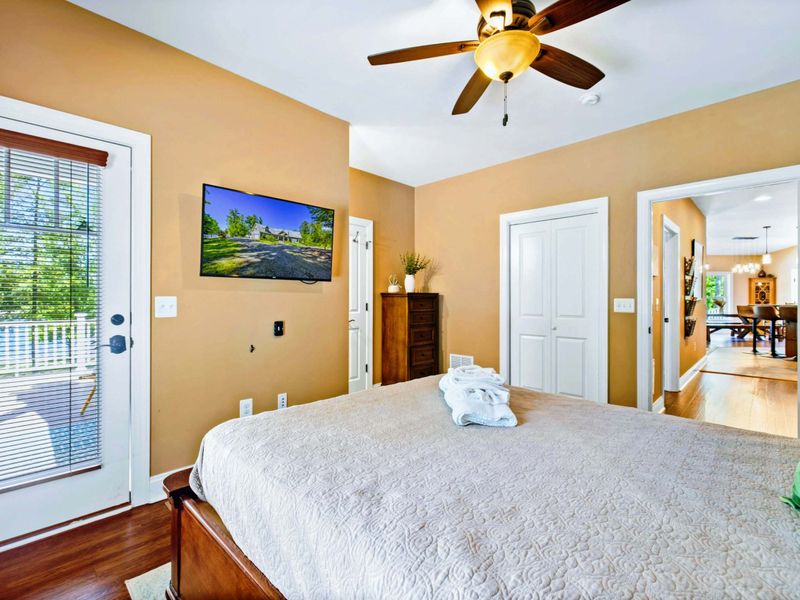Main level bedroom with queen bed, deck access and shared bathroom.