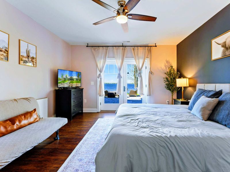 Suite with king bed, bathroom, and walkout patio.