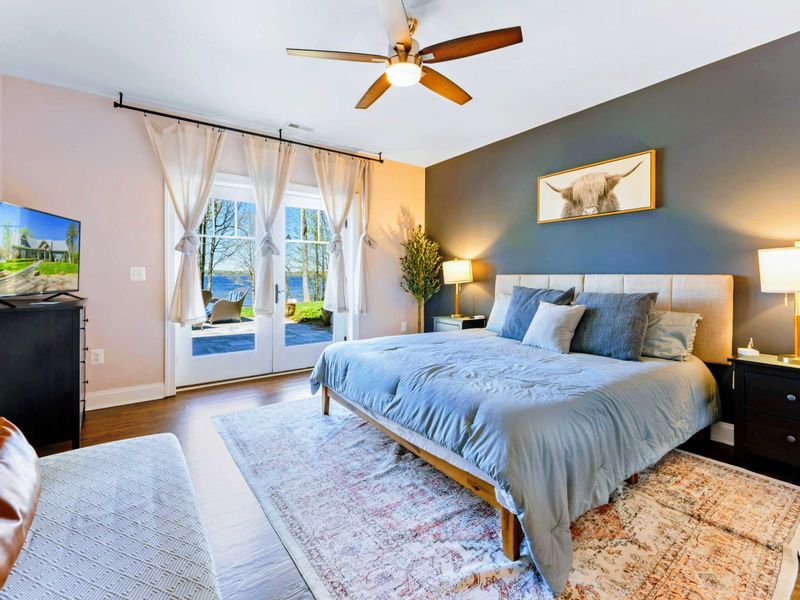 Suite with king bed, bathroom, and walkout patio.