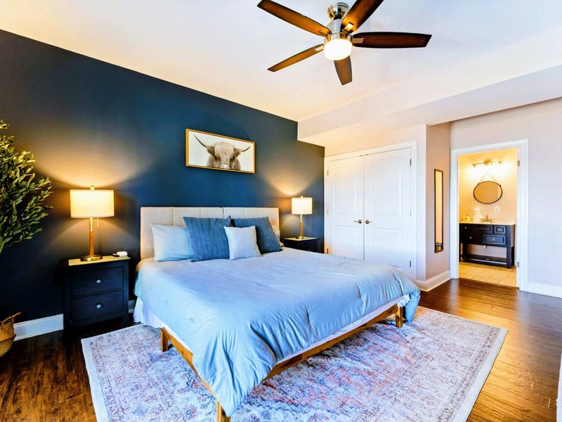 Suite with king bed, bathroom, and walkout patio.