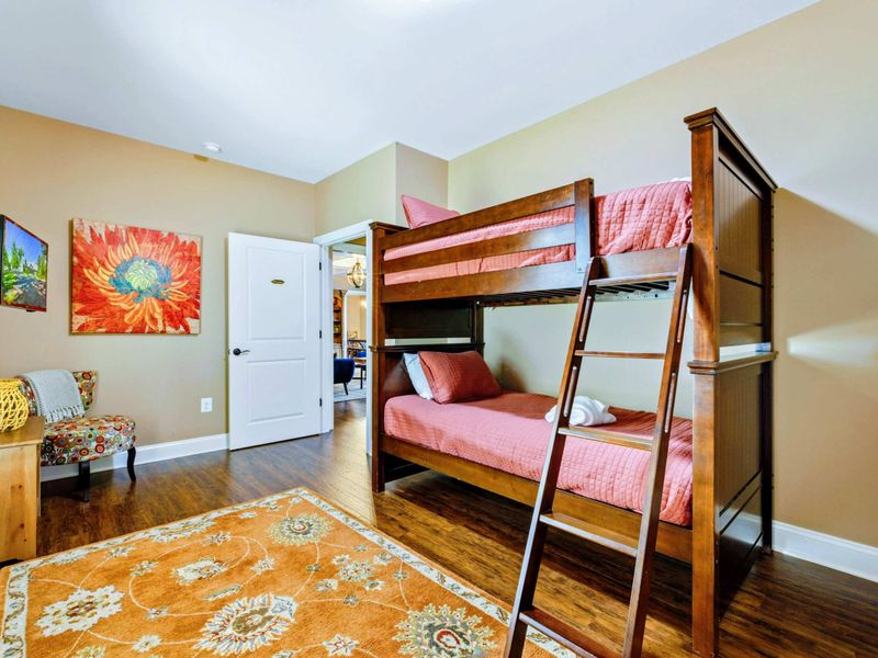 Main level room with two twin bunk beds and a suite bathroom.