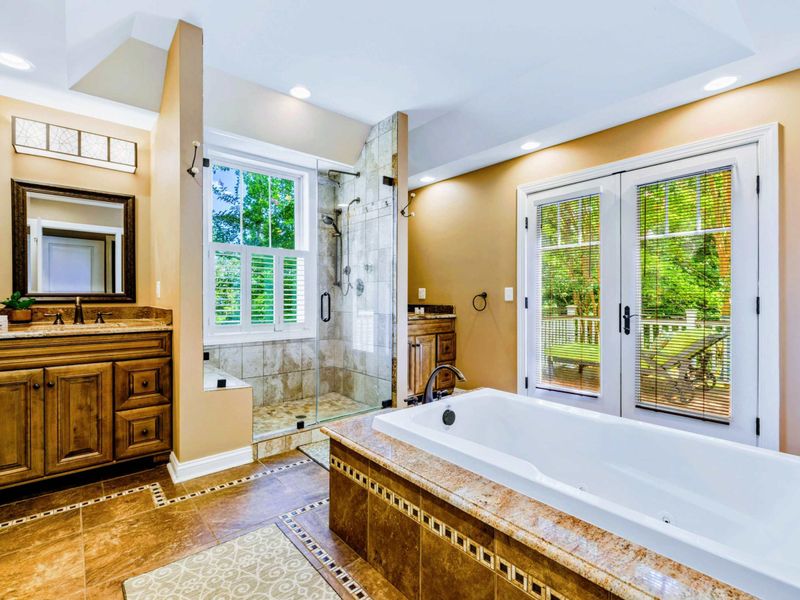 Suite bathroom with dual vanities, shower and jetted tub.