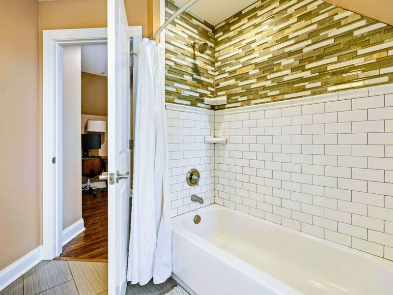 Large upper level primary suite bathroom complete with his and hers sinks.