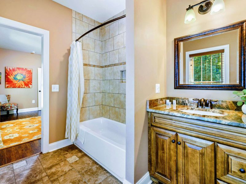 Main level room with two twin bunk beds and a suite bathroom.