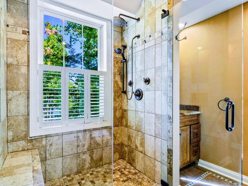 Suite bathroom with dual vanities, shower and jetted tub.
