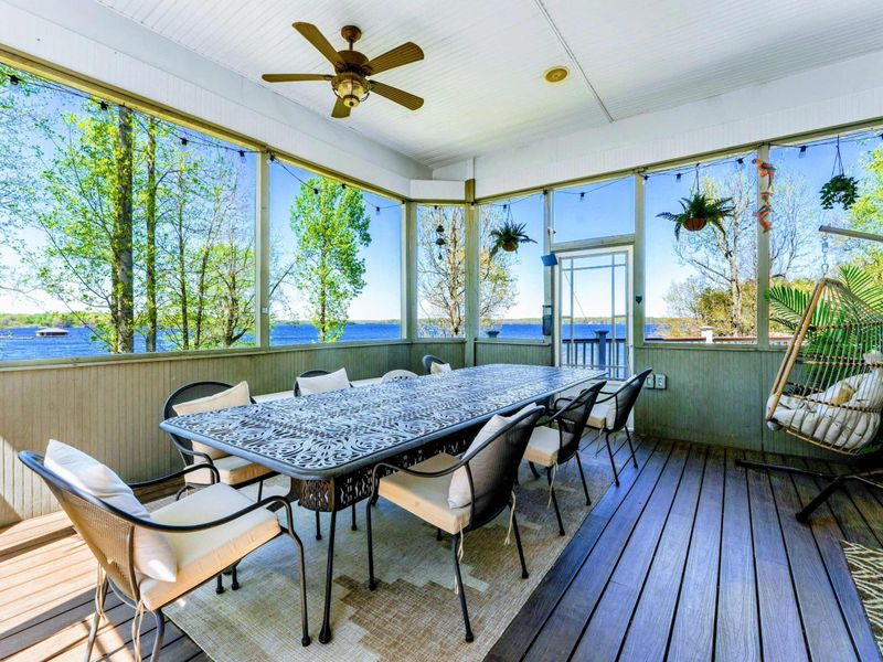 Indulge in lakeside feasts within confines of our screened-in porch with seating for up to 14.
