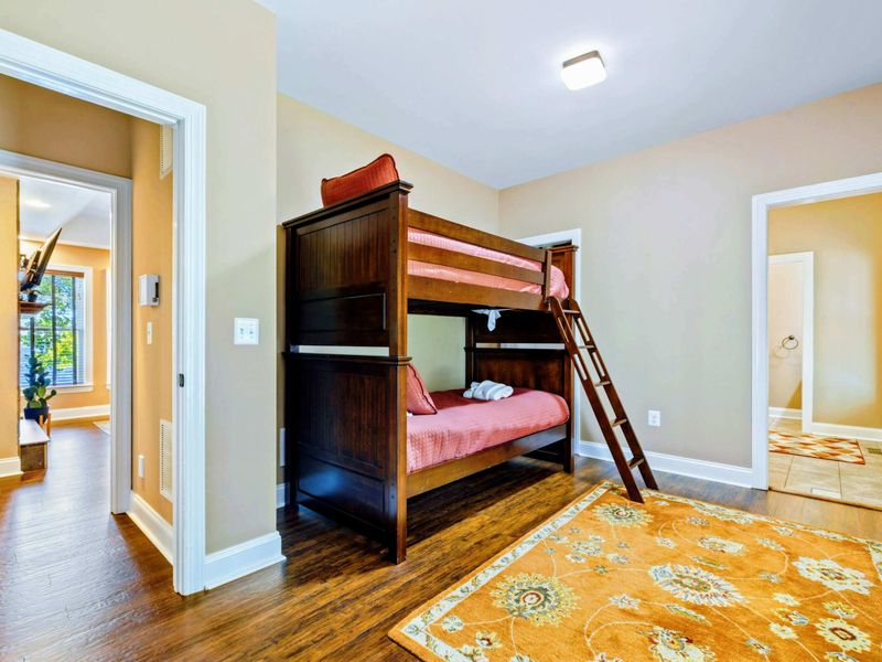 Main level room with two twin bunk beds and a suite bathroom.