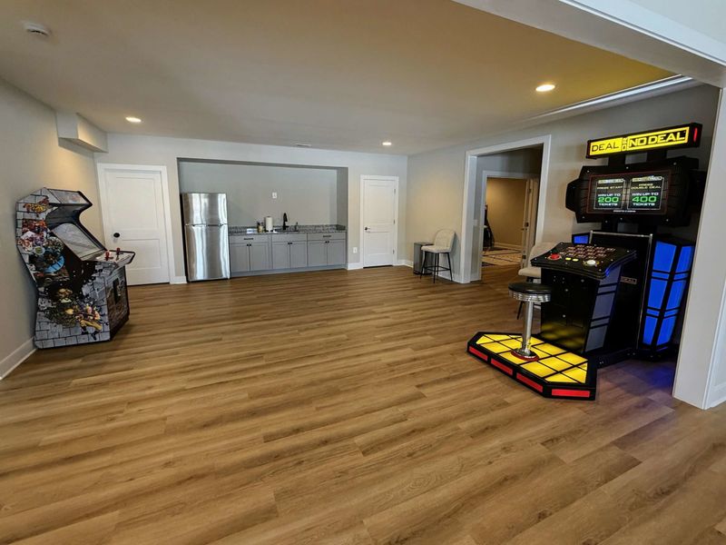 Room to Play, Room to Breathe – A wide-open lower level with pinball, Deal or No Deal, and plenty of space to move.