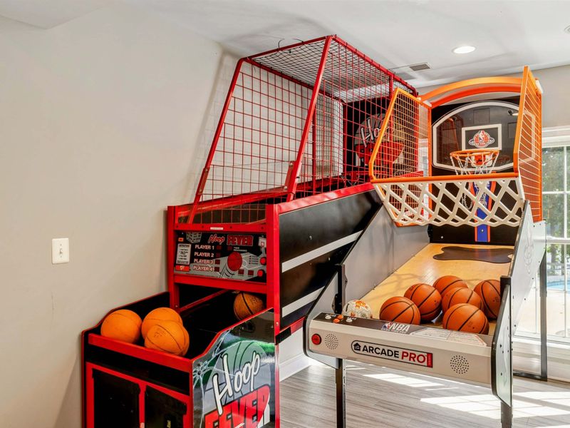 Game Room - Two basketball arcade machines side by side, with the pool visible through the window.