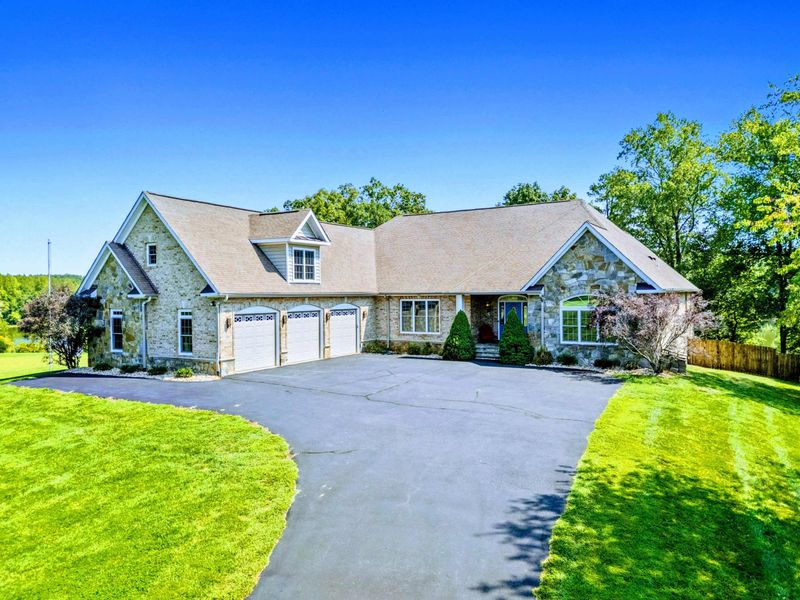 Exterior - The wide driveway and three-car garage provide plenty of room for the whole group to park.