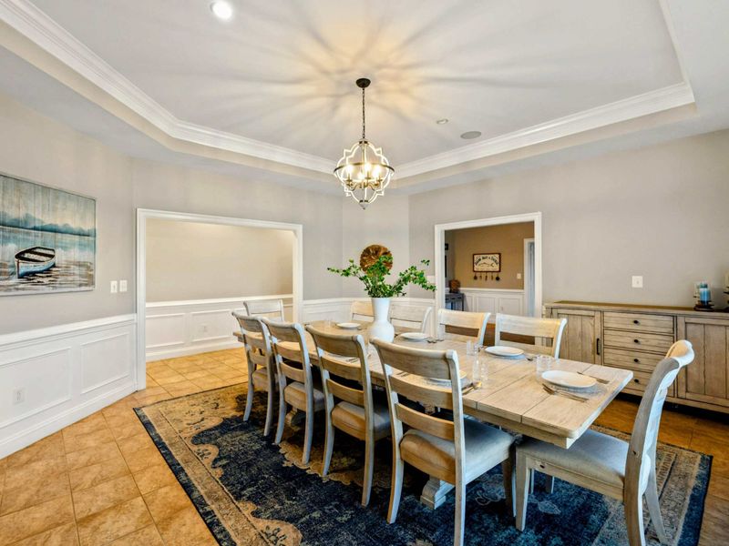 Dining Room - The opposite view shows the buffet, tray ceiling, and an open archway connecting to the hall.