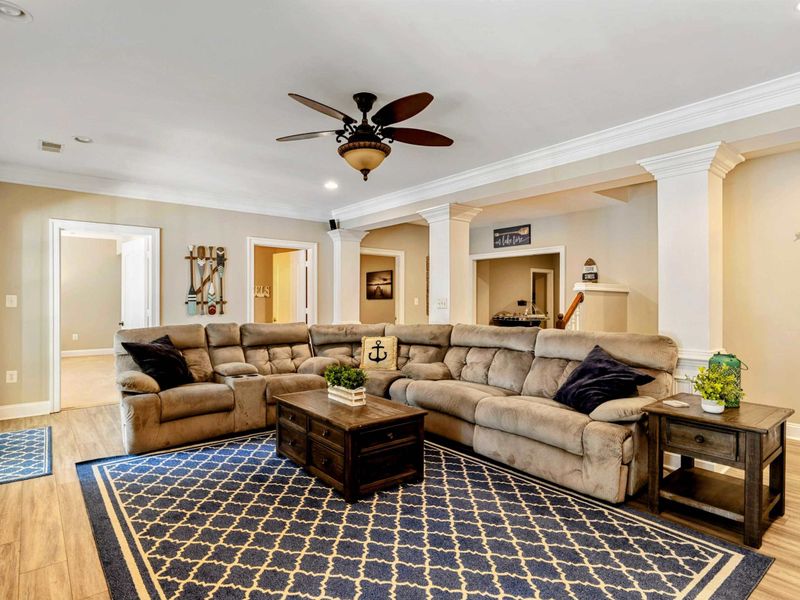 Living Area - The sectional wraps the lower-level lounge, with nautical decor and open sightlines to the hallway and bedrooms.