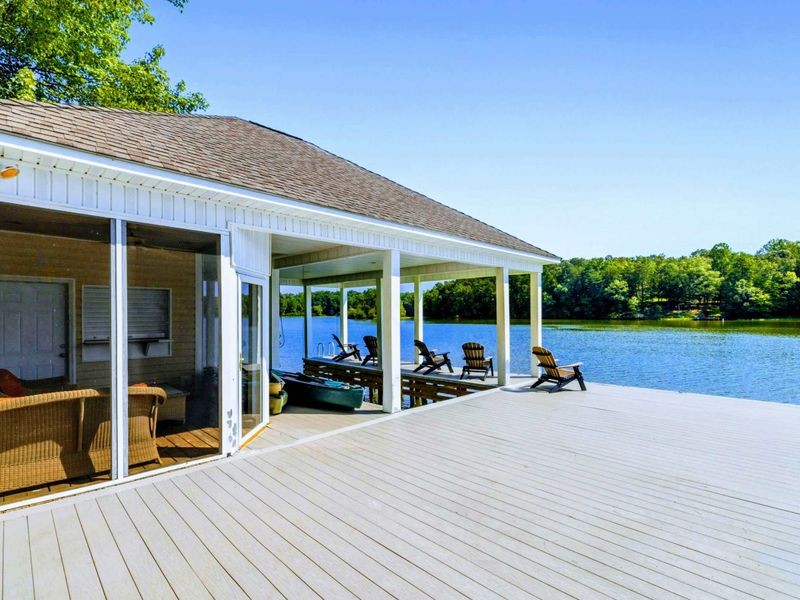 Dock - The spacious dock wraps around the boathouse, with Adirondack chairs, a swim ladder, and room to spread out.