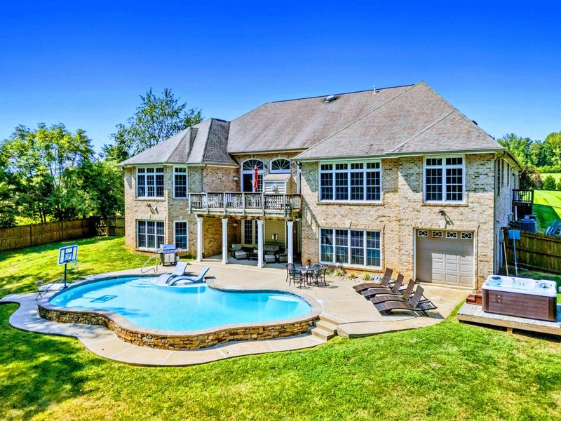Pool - The stone facade and upper balcony frame the pool area, with loungers ready for an afternoon in the sun.