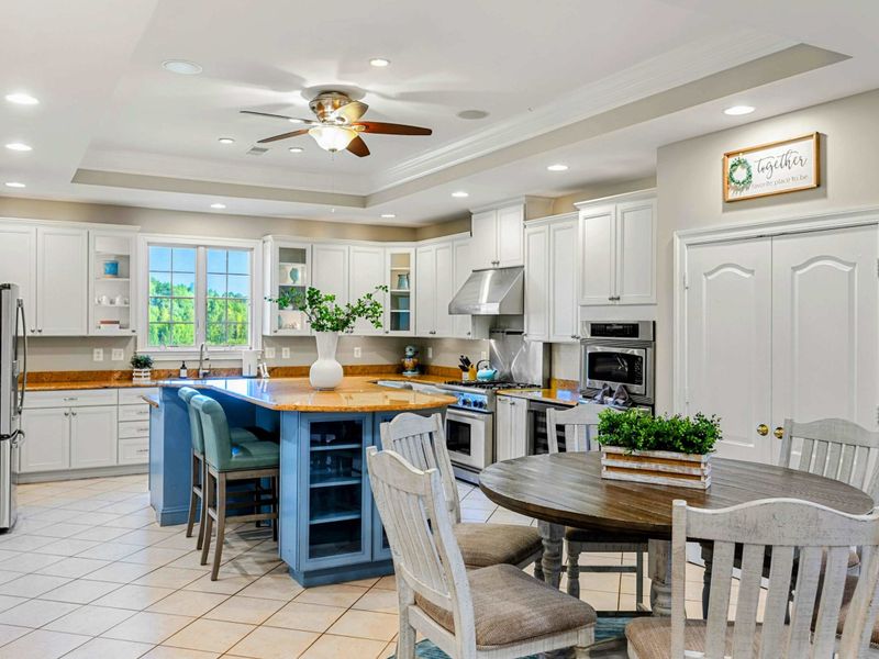 Kitchen - Looking from the island toward the breakfast nook, with the 'together' sign and dining table just beyond.