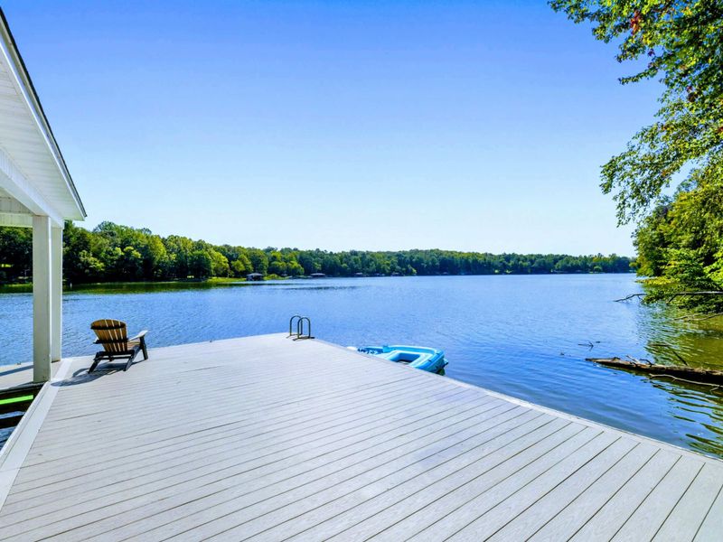 Dock - Morning coffee spot: an Adirondack chair at the dock's edge, the lake calm and the swim ladder just steps away.