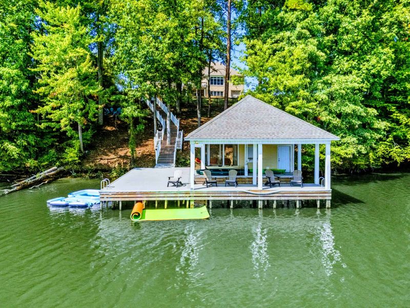 Boathouse - The covered boathouse from the water, with seating, floats, and the swim platform ready for the day.