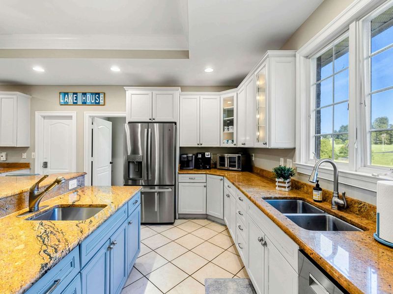 Kitchen - French-door fridge, double sinks, and a 'Lake House' sign set the tone for cooking at the lake.