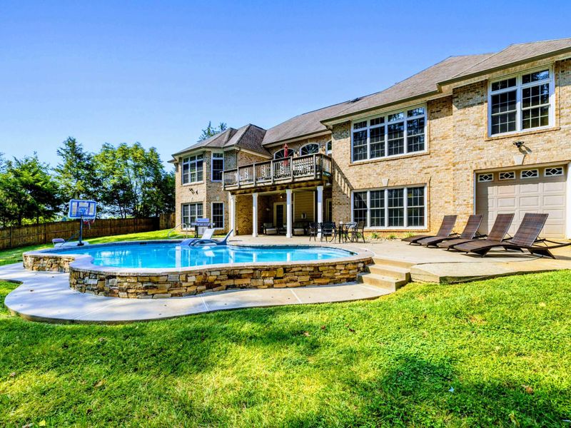 Pool - The stone pool edge and hot tub sit just steps from each other for easy transitions.