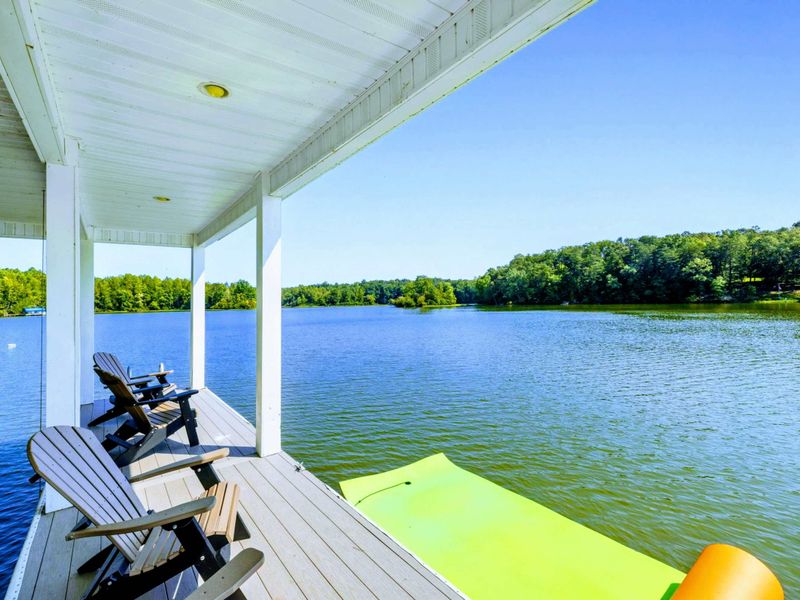 Dock - Lake views from the covered side of the dock, with floats staged and the cove stretching out ahead.