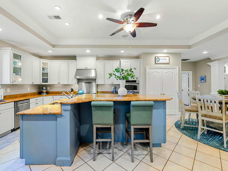 Kitchen - The island and bar seating face the dining nook, keeping the cook connected to the conversation.