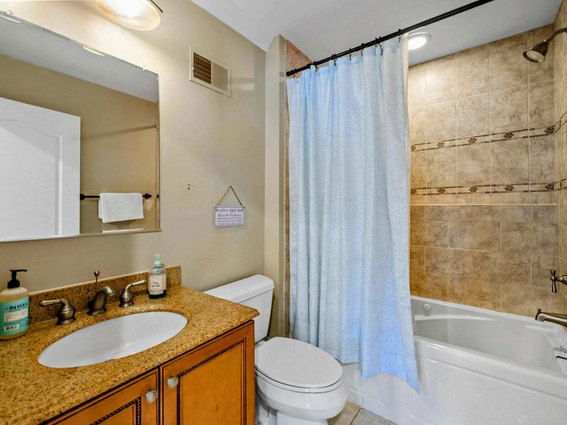 Upper Suite Bath - A full bathroom with tub/shower combo and granite vanity serves the upper suite.