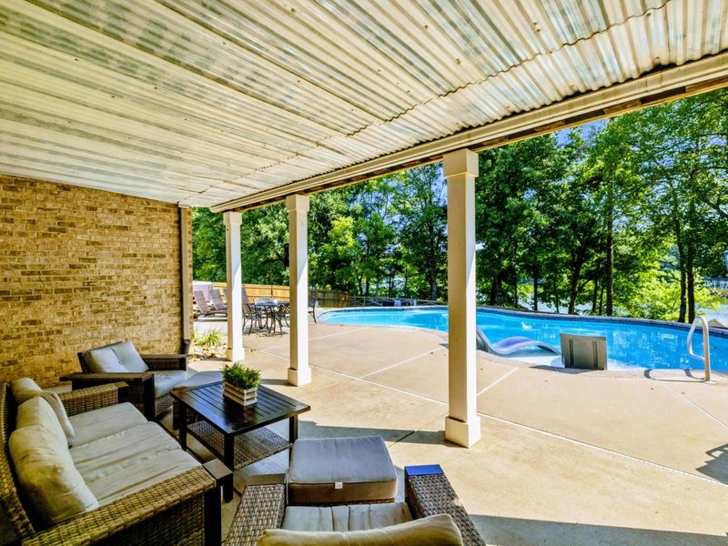 Covered Patio - The shaded patio beneath the deck offers comfortable seating and pool views, rain or shine.