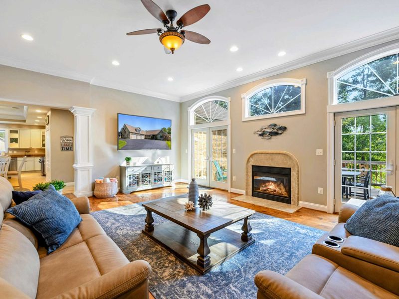 Living Room - The open-concept main level: living room flows to dining and kitchen, with natural light from every direction.