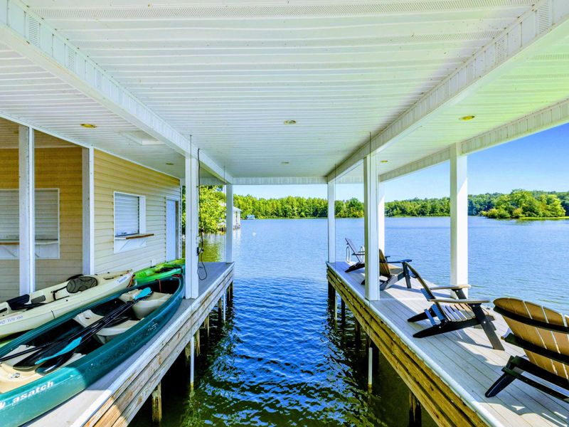 Dock - Kayaks stored on the side of the boathouse, paddles included, for a quick paddle around the cove.