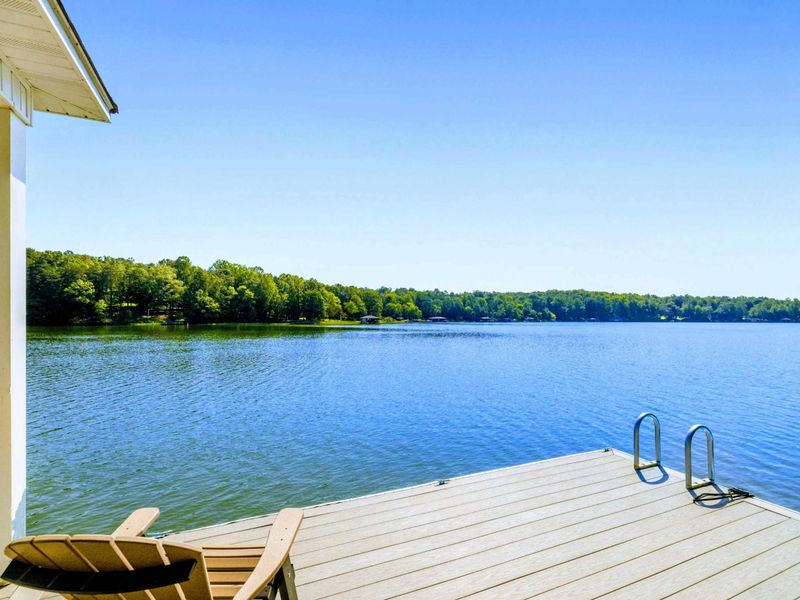 Dock - Adirondack chairs under the covered dock, with a kayak and floats tied up and ready to go.