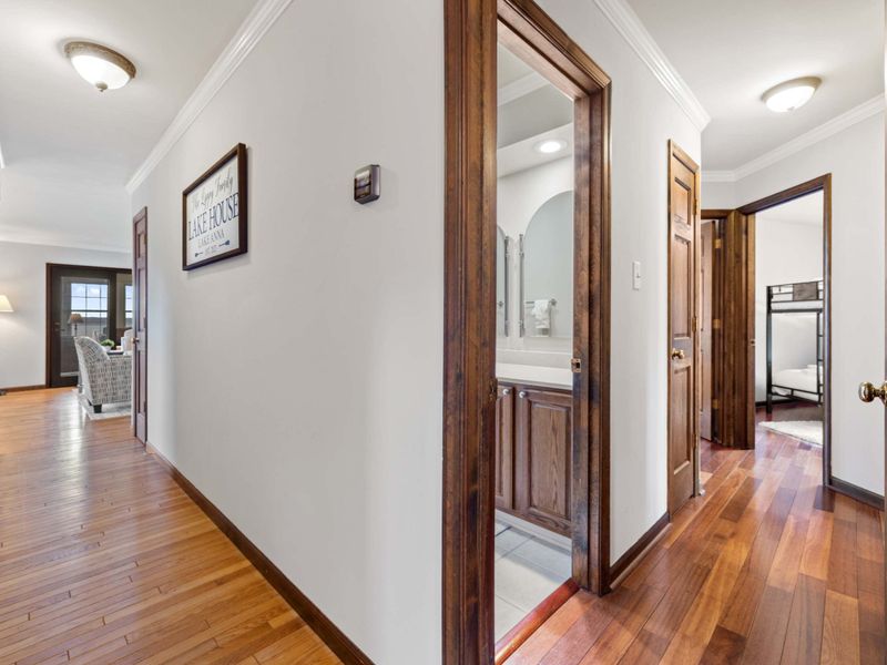 A welcoming hallway with gleaming wood floors leads to multiple rooms, creating a flow of inviting spaces