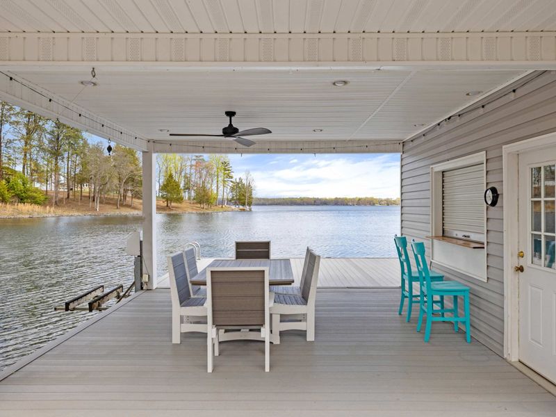 Spacious and breezy lakefront porch with a picturesque view, perfect for dining or simply enjoying the lakeside ambiance