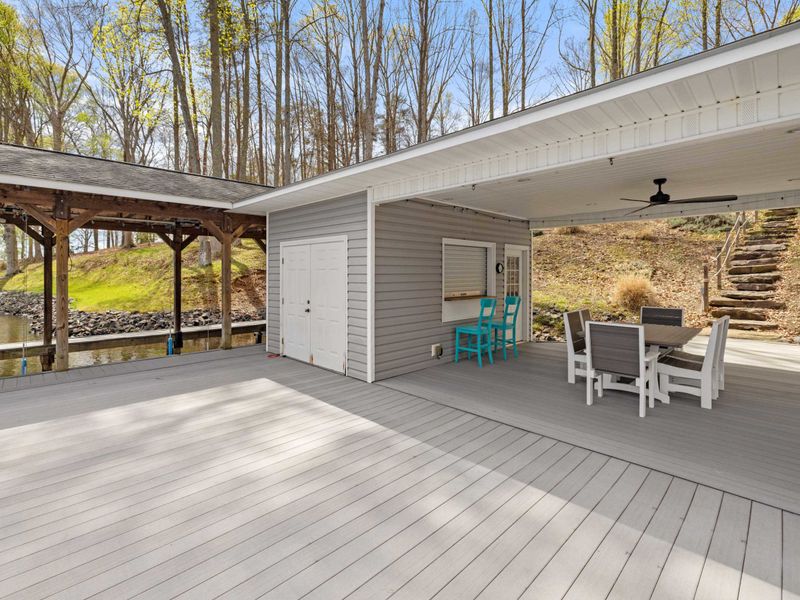 An expansive covered deck offers a peaceful waterfront setting with ample space for outdoor relaxation and dining