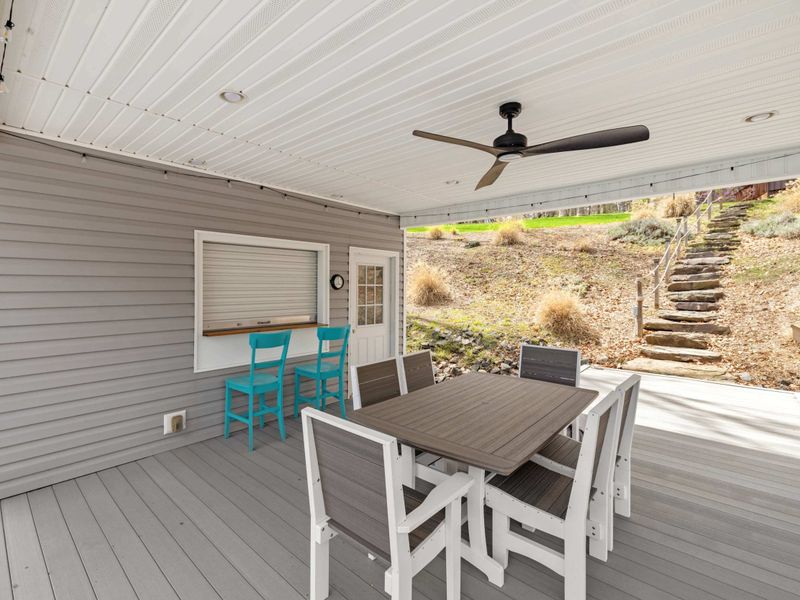 Charming lakeside dining area with a stunning waterfront view, perfect for al fresco meals and relaxation