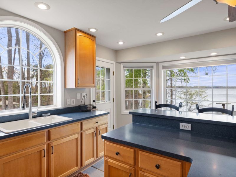 A spacious and well-lit kitchen with modern appliances and wooden cabinetry